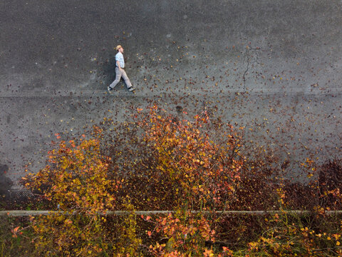 Aerial view of a person laying down on the ground walking into the unknown, Autumn, Novi Ligure, Piedmont, Italy.