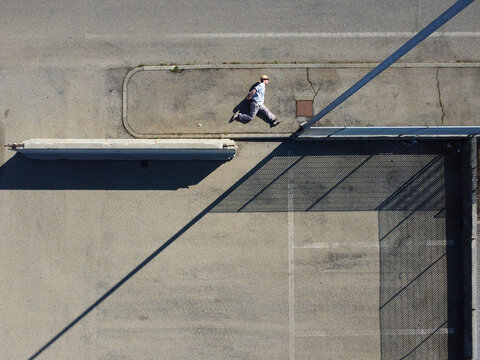 Aerial view of a person laying down on the ground jump in industrial area in Serravalle, Scrivia, Piedmont, Italy.