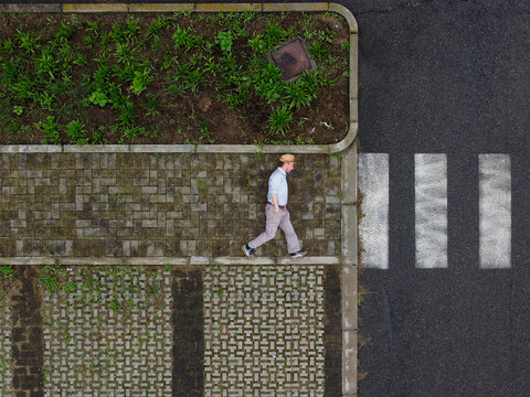 Aerial view of a person laying down on the ground walking into the unknown, Tortona, Piedmont, Italy.