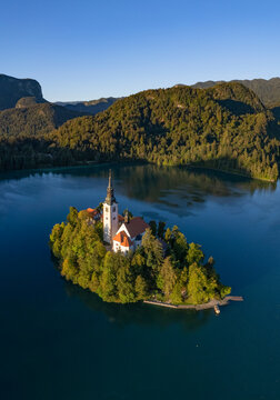 Aerial drone view of church on small island in middle of lake Bled, Slovenia.