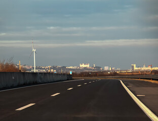 Fototapeta na wymiar Road from Vienna to Bratislava. Panorama of Bratislava on the horizon.