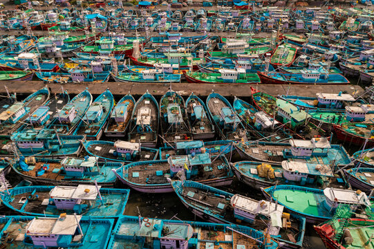 Aerial view of many boats and fishing boats docket at Malpe New Port, Udupi, Karnataka, India.