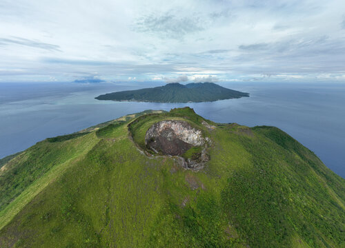 Aerial View of Ruang Volcano crater next to Tulandang Island, Indonesia.