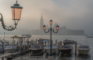 Gondolas in Venice at sunrise in morning fog. Veneto, Italy.. - 741683696