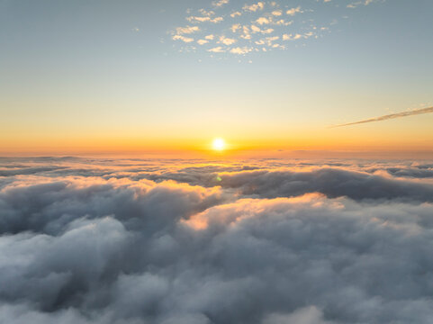 Aerial view of a beautiful sunset as seen from the plane, view above the clouds, Amalfi Coast, Salerno, Campania, Italy.