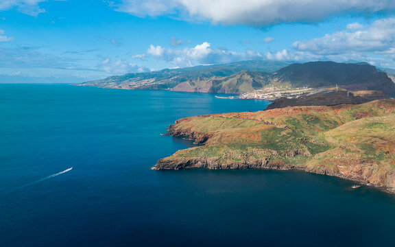 Aerial drone view of the Eastern Peninsula coastline with a boat, Madeira island, Portugal.