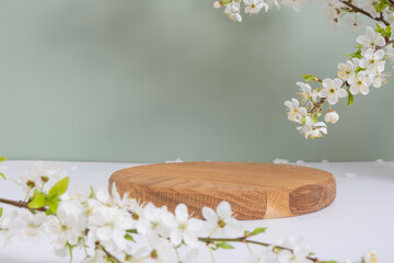 Empty wooden podium or pedestal with spring bloom. Mock up for cosmetic products