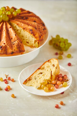 Delicious homemade grape sponge cake with noble mold cheese on a stone background.