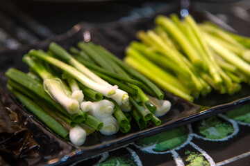 View of green onion and water parsley on the plate