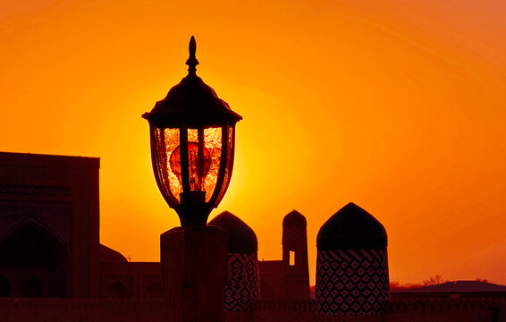 Silhouette of a lamp and minarets at sunset, Khiva, Khorazm, Uzbekistan