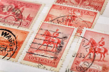 Ukraine, Kiyiv - February 3, 2024.Postage stamps from Australia.Collection  vintageof stamps and magnifying glass.Postage stamps from different countries and times - obrazy, fototapety, plakaty
