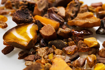 Yellow and orange raw amber pieces of different shapes. Raw materials for jewelry.