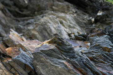 Stone pattern, granite rock surface, colored rock detail texture, rock structures, marble granite deposit. GRAY GRANITE STRIATED ROCK BACKGROUND
