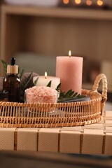 Beautiful composition with different spa products on wicker bench indoors