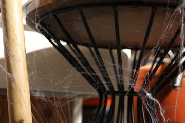 Old cobweb on chair in room, closeup