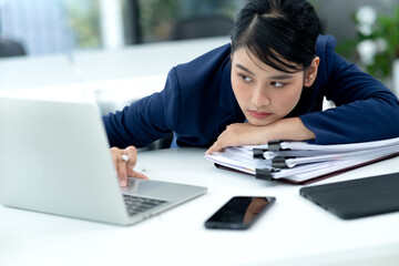 young businesswoman Wearing a suit bending over the table