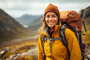 Happy woman hiker with backpack hiking in mountains. Travel Lifestyle concept.