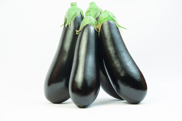 ripe dark eggplants on a white background. autumn eggplants on a light texture