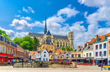 Amiens old town Saint-Leu quarter with colorful houses, restaurants and Amiens Cathedral Basilica...