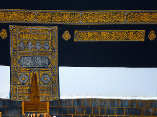 The golden doors of the Holy Kaaba closeup, covered with Kiswah. Massive lock on the doors....