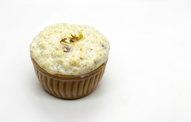 Cracked Wheat Kheer or Payesh Garnished with Cashew, Pistachio, Almond in a Bowl Isolated on White Background with Copy Space, Also Known as Ksheeram, Milk Pudding or P