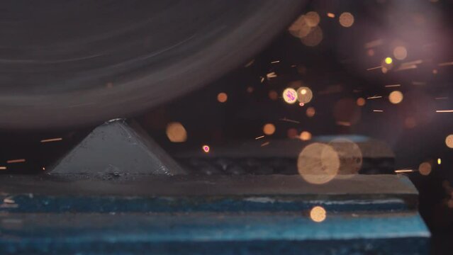 Explore the precision and power of metal fabrication as an angle grinder produces cascades of glowing sparks in breathtaking 4K slow motion.
