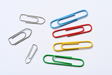 colorful paper clips on white background close-up