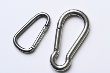 silver colored carabiner close-up on white background