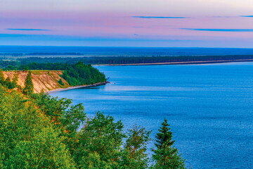 Seascape - the shore of Lake Onega in selective focus against the background of clouds at...