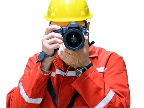 Man photographer at a construction site in a helmet with a DSLR camera on a white background. Close-up
