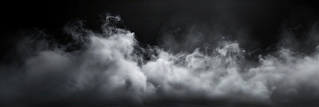 black and white photo showcasing smoke billowing against a black background