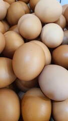 Close up of  randomly stacked chicken eggs sold at the market as a background.