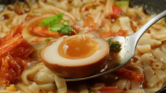 Asian fast food noodles with soybean sprouts, parsley and pickled or century egg close-up. Cooking instant noodles in boiling water with spices. Instant noodles, or instant ramen, is a type of food