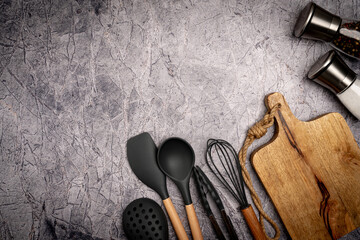 Kitchen silicone utensils for cooking tools on concrete background, top view, flat lay. Kitchenware...
