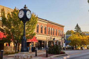 Golden Hour on Historic Plymouth Street with Clock and Autumn Trees