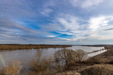 early spring flood, high water in the countryside, river overflowing its banks, trees in the water,...