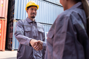 Asia Japanese logistic engineer worker or foreman working and hand shake with engineer woman at...
