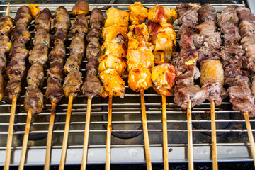 grilling espetinho de carne on a eletric grill (brazilian meat skewer)