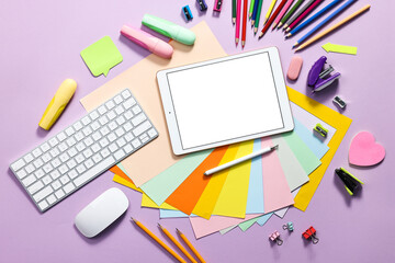 Modern tablet, keyboard and stationery on violet background, flat lay. Space for text