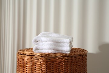 Soft terry towels on wicker basket indoors