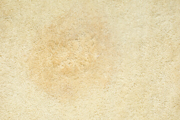 Wet spot on beige carpet as background, top view