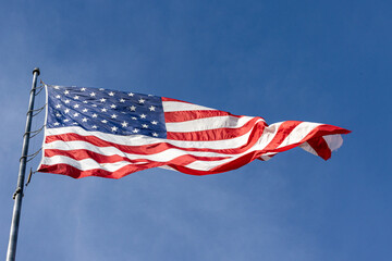 american flag flying in the sky off flag pole