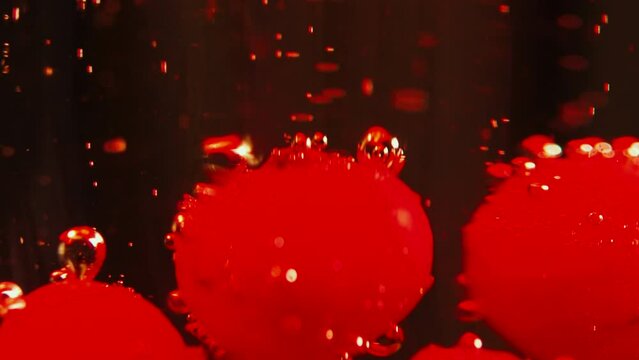 bolas rojas abstractas con burbujas movi&eacute;ndose en un l&iacute;quido rojizo