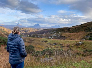 Naklejka premium Woman looking out over mountain view in Scotland