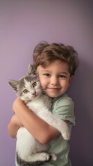 A little boy holding a cat in his arms