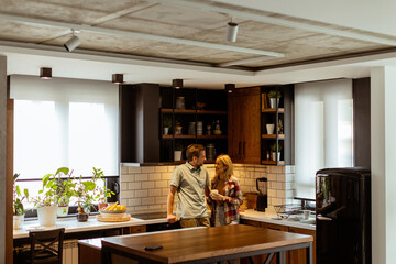 Embraced in Warmth: A Couples Tender Moment in a Cozy Kitchen at Dusk