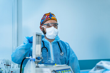 Doctor wearing mask and protective suit in the intensive care unit