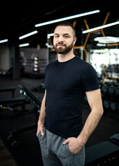 Fototapeta na wymiar Handsome man with beard is engaged in gym