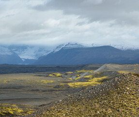 Iceland autumn tundra landscape near Haoldukvisl glacier, Iceland. Glacier tongue slides from the...