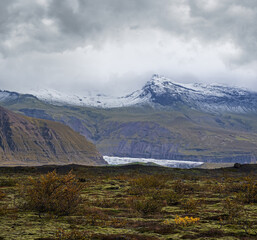 Iceland autumn tundra landscape near Haoldukvisl glacier, Iceland. Glacier tongue slides from the...